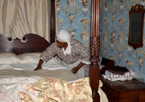 Goody Morris makes up a bed. Photograph by J. D. Kay